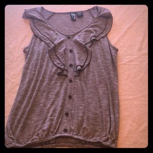 Grey Blouse with buttons sewn on the front.